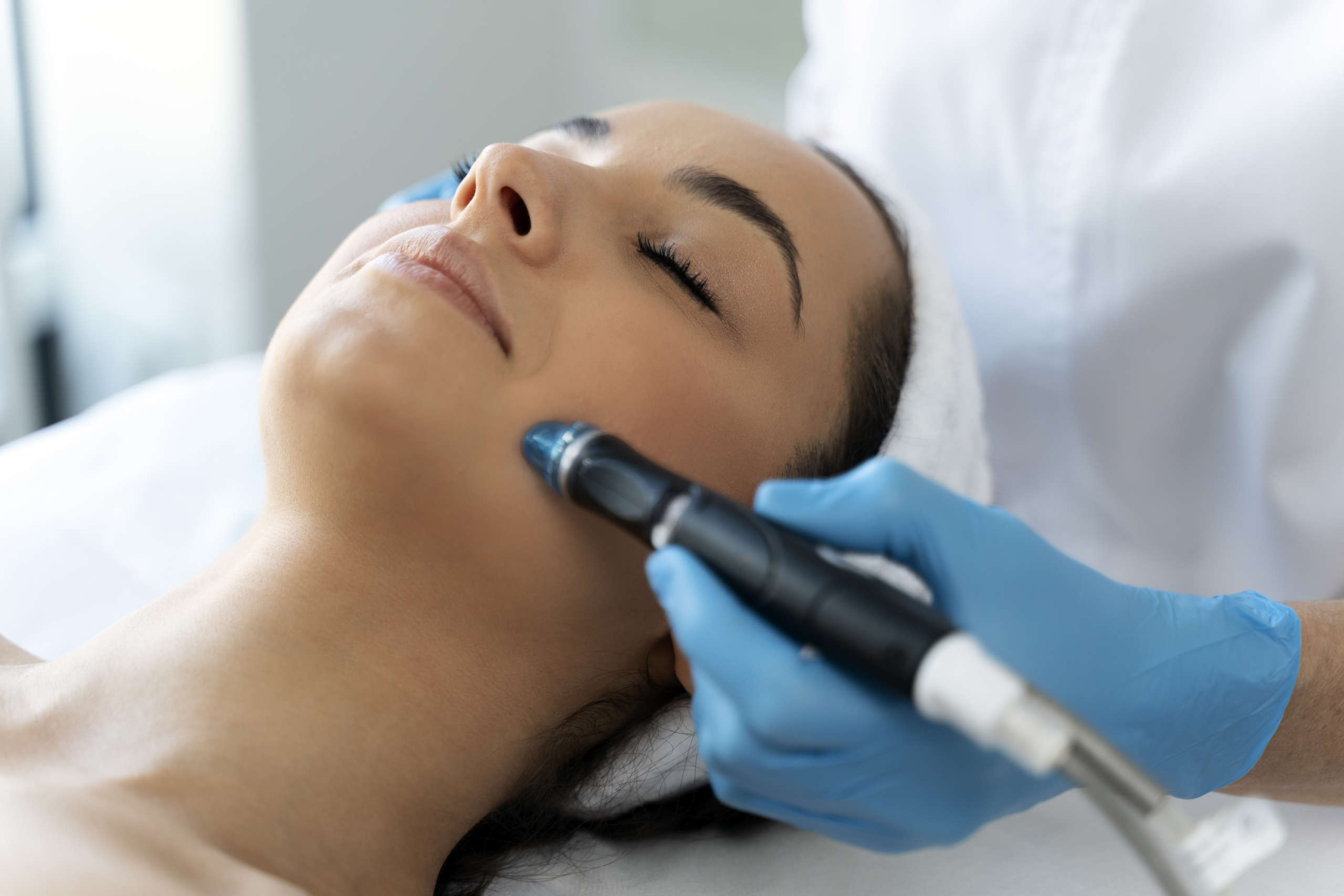 close up of woman getting facial hydro microdermabrasion peeling treatment